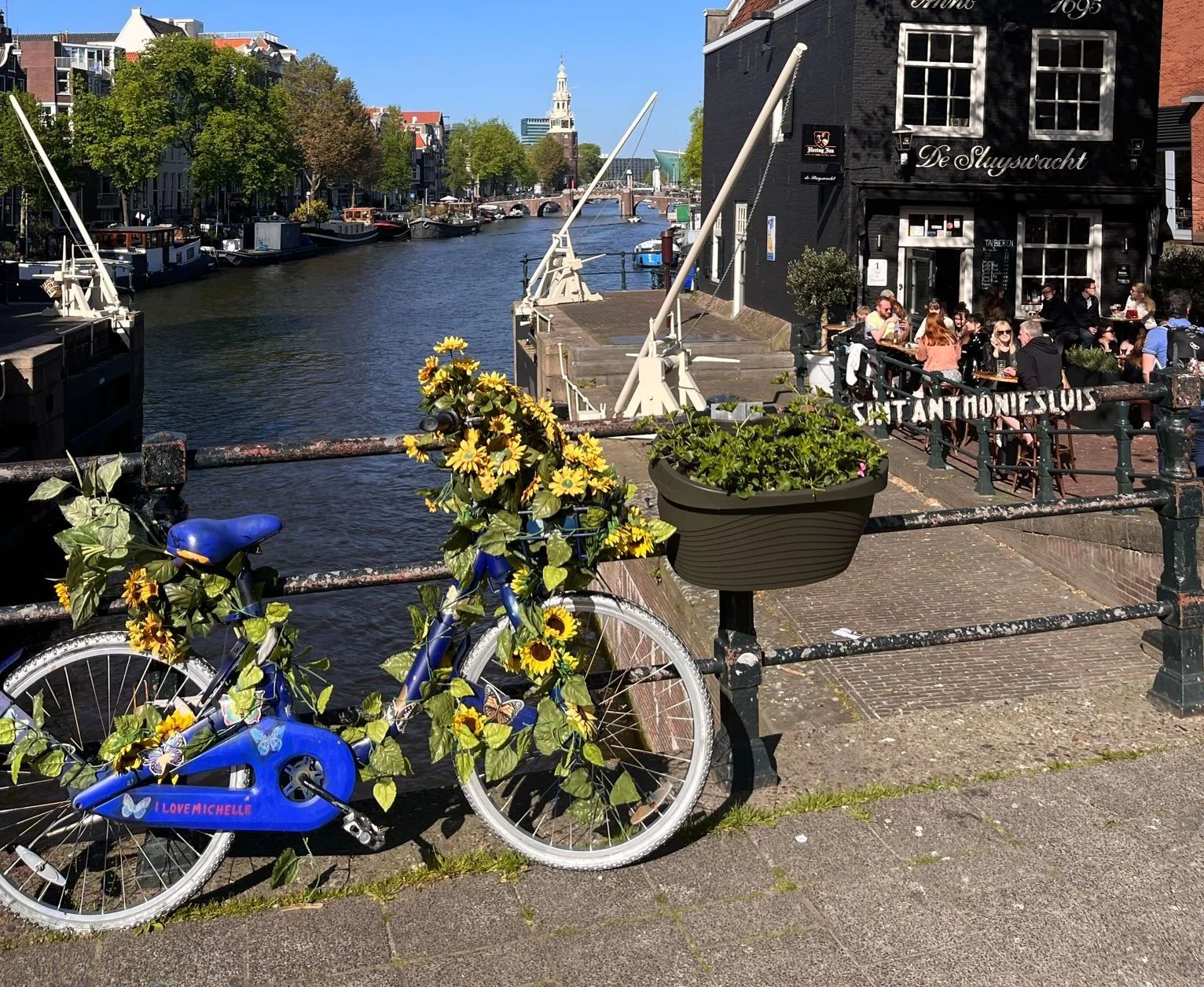 Bicycle with flowers beside an Amsterdam canal